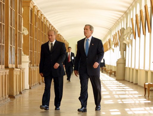 President George W. Bush walks through the halls of St. Petersburg State University with President Vladimir Putin before a question and answer session with students in St. Petersburg, Russian on May 25, 2002. White House photo by Paul Morse.