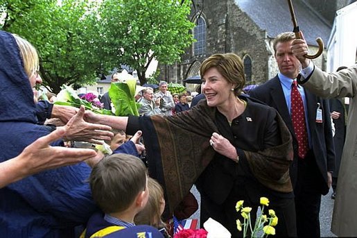 Mrs. Bush greets the crowd gathered outside the Notre Dame de Paix church in Saint-Marie-Eglise, France, May 27, 2002. White House photo by Susan Sterner.