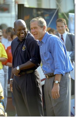 President George W. Bush takes in the excitement of the White House Fitness Expo on the South Lawn with Dallas Cowboys Running Back Emmitt Smith June 20. White House photo by Eric Draper.