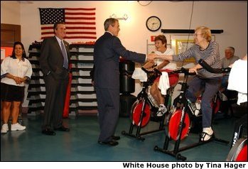 Accompanied by the Governor of Florida, his brother Jeb Bush, President George W. Bush visits senior citizens participating in an aerobic "spinning class" at the Marks street Senior Recreation Complex in Orlando, Fla., Friday, June 21, 2002. White House photo by Tina Hager.