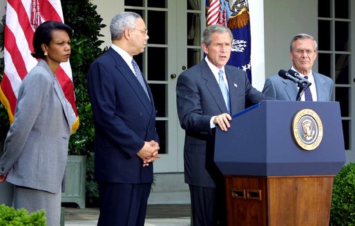 President George W. Bush discusses his plan for peace in the Middle East as Dr. Condoleezza Rice (left), Sec. Colin Powell (center) and Sec. Donald Rumsfeld stand by his side in the Rose Garden Monday June 24. White House photo by Paul Morse.