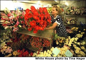 White House Florist Wendy Elsasser prepares an arrangement of red Gerbera Daises as one of the many bouquests to be used at the State Dinner for Polish President Alexander Kwasniewski tonight, July 17. White House photo by Tina Hager.