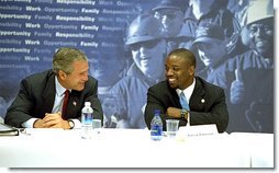 President George W. Bush talks with Patrick Patterson during a roundtable discussion on welfare reform in Charleston, S.C., Monday, July 29. 