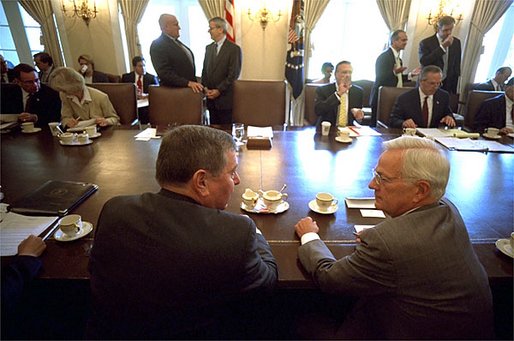 Shortly before the President arrives for his Cabinet meeting, Attorney General John Ashcroft and Secretary of Treasury Paul O'Neill talk in the Cabinet Room at the White House Wednesday, July 31. White House photo by Eric Draper.