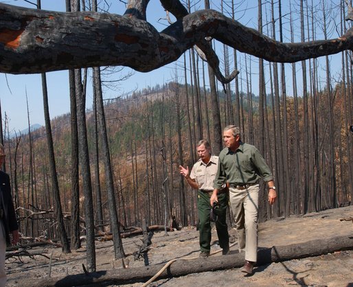 President George W. Bush tours the Squires Peak Fire Area in Medford, Ore., with Ron Wenker of the Medford Bureau of Land Management Properties District, Thursday, Aug. 22, 2002.