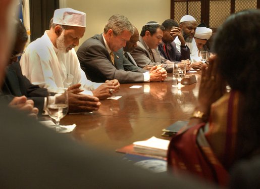 President W. Bush prays with Inter-Faith Leaders in the Roosevelt Room at the White House Friday, September 6, 2002. White House photo by Tina Hager.