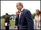 Flanked by interpreters, President George W. Bush and Italian Prime Minister Silvio Berlusconi leave a news conference after Berlusconi's arrival at Camp David, Saturday, Sept. 14, 2002. White House photo by Eric Draper.