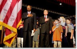 President George W. Bush pledges allegiance to the flag with Secretary of Education Rod Paige at a Pledge Across America event at East Literate Magnet School in Nashville, Tennessee on Tuesday, Sept. 17, 2002. White House photo by Paul Morse.