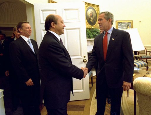 President George W. Bush greets Russian Foreign Minister Igor Ivanov, center, and Russian Defense Minister Sergei Ivanov, left, as they walk into the Oval Office, Friday, Sept. 20, 2002. White House photo by Tina Hager.