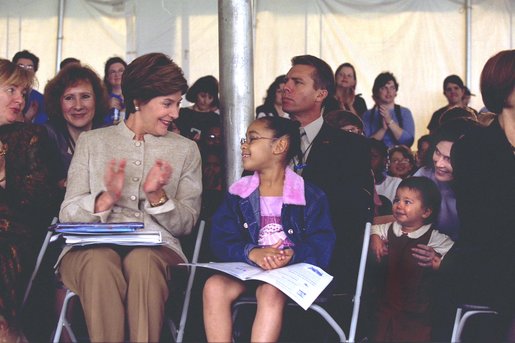 Laura Bush applauds at the end of a reading by renowned children's author and illustrator, Eric Carle Saturday, October 12, 2002 at the Second Annual National Book Festival on the held on the west side of the Capitol. White House photo by Susan Sterner.
