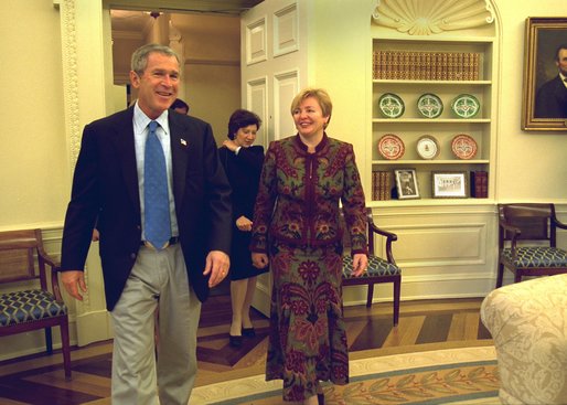 President George W. Bush laughs with Ludmila Putina, wife of Russian Federation President Vladimir Putin, during an impromptu tour of the Oval Office Saturday, October 12, 2002. Mrs. Putina then joined Laura Bush on a visit to the Second Annual National Book Festival on the west side of the Capitol. More than 70 authors, story tellers and athletes read from their works, signed books and encouraged reading for all ages. White House photo by Susan Sterner.