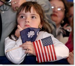 Holding the colors of South Carolina and America, a young girl listens to President George W. Bush during the South Carolina Welcome in Columbia, S.C., Thursday, Oct. 24. White House photo by Eric Draper.