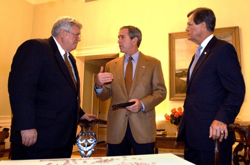 President George W. Bush talks with House Speaker Dennis Hastert and Senate Republican Leader Trent Lott while watching election returns in the White House residence Tuesday night, Nov. 5, 2002. White House photo by Eric Draper.