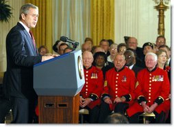 President George W. Bush makes remarks to American and British veterans ( seated in background) in the East Room of the White House on Veteran's Day, November 11, 2002  White House photo by Paul Morse