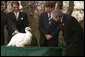 President George W. Bush looks over Katie, the National Thanksgiving Turkey, during the annual ceremonial pardoning in the Rose Garden, Tuesday, Nov. 26. "By virtue of this pardon, Katie is on her way not to the dinner table, but to Kidwell Farm in Herndon, Virginia. There she'll live out her days as safe and comfortable as she can be," said President Bush before granting the pardon. White House photo by Paul Morse.