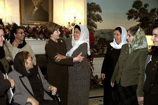 Laura Bush is embraced during a meeting with women teachers from Afghanistan in the Diplomatic Reception Room of the White House, Dec. 4, 2002. White House photo by Susan Sterner.