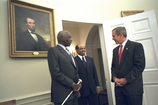 President George W. Bush welcomes President Daniel arap Moi of Kenya, left, and Prime Minister Meles Zenawi of Ethiopia to the Oval Office Dec. 5. "We welcome two strong friends of America here; two leaders of countries which have joined us in the -- to fight the global war on terror; two steadfast allies, two people that the American people can count on when it comes to winning the first war of the 21st century," said President Bush during their meeting in the Cabinet Room. White House photo by Eric Draper