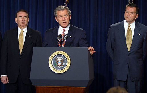 President George W. Bush discusses his smallpox vaccination program during a press conference as Secretary of Health & Human Services Tommy Thompson, left, and Director of the Office of Homeland Security Tom Ridge in the Dwight D. Eisenhower Executive Office Building Friday, Dec. 13. White House photo by Paul Morse.
