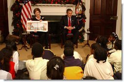 President George W. Bush and Laura Bush read "'Twas the Night Before Christmas," to a class of third-graders during the White House Story Hour in the Roosevelt Room Tuesday, Dec. 17.  White House photo by Tina Hager