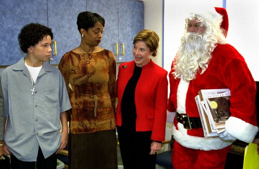 Laura Bush meets with Iran Brown, left , the 13-year-old victim of the Washington-area sniper, and his mother, Lisa Brown, after visiting with children in the neurology and orthopedic units at the Children's National Medical Center in Washington, D.C. Thursday, December 12, 2002. Mrs. Bush invited Brown to co-host the annual children's Christmas program. White House photo by Susan Sterner.