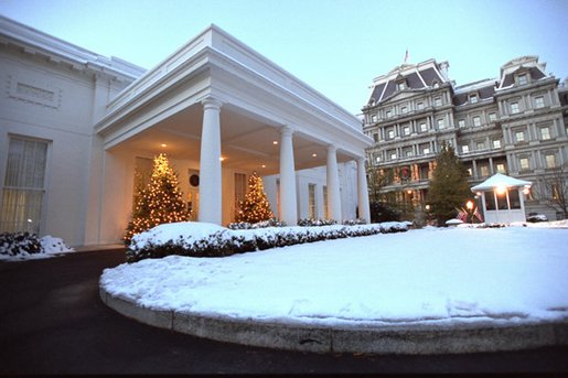 The West Wing entrance glows as the sun rises on a snowy day at the White House, Friday, Dec. 6, 2002. White House photo by Tina Hager.
