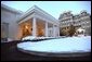The West Wing entrance glows as the sun rises on a snowy day at the White House, Friday, Dec. 6, 2002. White House photo by Tina Hager.