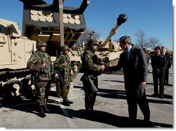 President George W. Bush greets army soldiers in front of tank equipment during a visit to Fort Hood in Killeen, Texas, Friday, Jan. 3, 2003.  White House photo by Eric Draper