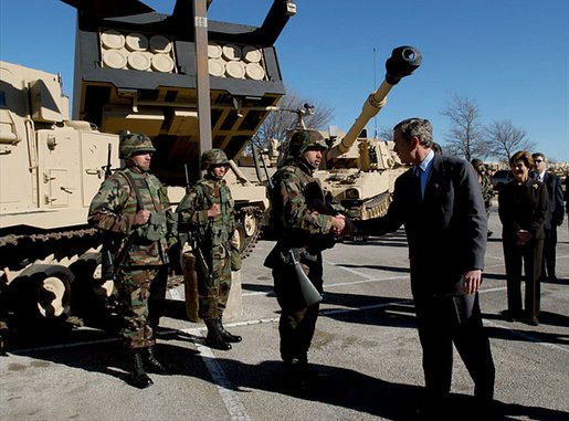 President George W. Bush greets army soldiers in front of tank equipment during a visit to Fort Hood in Killeen, Texas, Friday, Jan. 3, 2003. White House photo by Eric Draper.