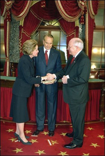 In his role as President of the Senate, Vice President Dick Cheney presides over the swearing in of 35 new senators as part of the opening of the 108th Congress Tuesday Jan. 7, 2003. Here, the Vice President congratulates newly-elected Senator Elizabeth Dole, R-N.C., in the Old Senate Chamber of the Capitol as her husband, former Senator Bob Dole, looks on. White House photo by David Bohrer.