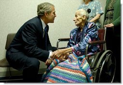 President George W. Bush visits with 94-year-old Anna Tovcimak, who is a hospice patient, after a roundtable discussion on Medical Liability Reform at Mercy Hospital in Scranton, Pa, Jan. 16, 2003. "I appreciate you all. giving me a chance to talk about a significant problem which faces America," said President Bush in his remarks. "And that problem is the fact that our medical liability system is broken, and therefore, a lot of Americans don't have access to affordable health care."  White House photo by Tina Hager