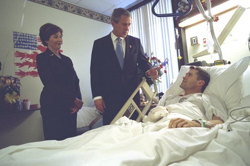 President George W. Bush and First Lady Laura Bush visit with Army Staff Sergeant Michael McNaughton, of Denham Springs, Louisiana, at Walter Reed Army Medical Center in Washington, D.C., Friday, January 17, 2003. Sergeant McNaughton was wounded on January 9 in Afghanistan. The First Couple visited four other wounded soldiers at the hospital. White House photo by Eric Draper