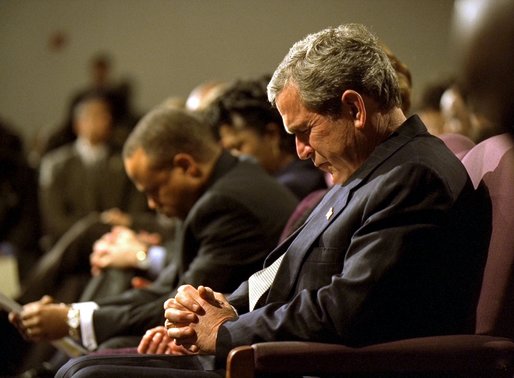 President George W. Bush prays during a church service honoring Dr. Martin Luther King, Jr. at the First Baptist Church of Glenarden in Landover, Md., Jan. 20, 2003. "It is fitting that we honor this great American in a church because, out of the church comes the notion of equality and justice," said the President in his remarks. White House photo by Eric Draper.