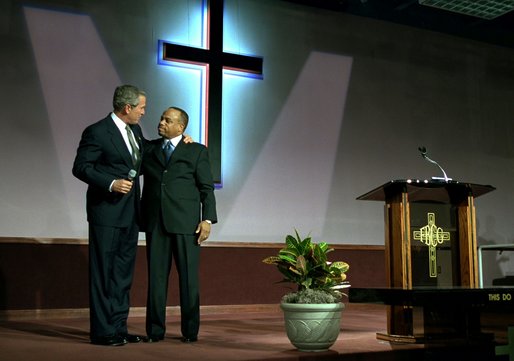 President George W. Bush embraces Pastor John K. Jenkins, Sr. of the First Baptist Church of Glenarden during an annual service honoring Dr. Martin Luther King, Jr. in Landover, Md., Monday, Jan. 20, 2003. "And even though progress has been made, Pastor -- even though progress has been made, there is more to do," said the President in his remarks. "There are still people in our society who hurt. There is still prejudice holding people back. There is still a school system that doesn't elevate every child so they can learn." White House photo by Susan Sterner.