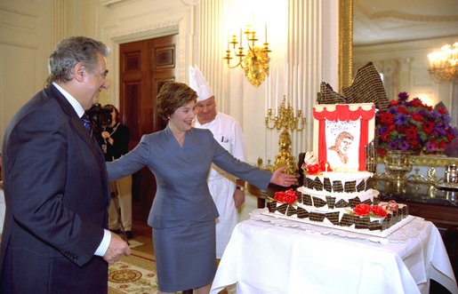 Laura Bush presents the legendary Placido Domingo with a birthday cake inscribed, "Happy Birthday, Maestro!" during a luncheon held in the East Room in honor of his 62nd birthday Tuesday, Jan. 21, 2003. Domingo has been Artistic Director of the Washington Opera since the 1996-97 season. White House photo by Susan Sterner.