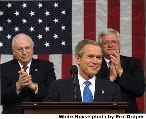 President George W. Bush reacts to applause while delivering the State of the Union address at the U.S. Capitol, Tuesday, Jan. 28, 2002. Also pictured are Vice President Dick Cheney, left, and Speaker of the House Dennis Hastert.