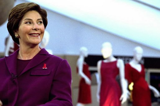 Laura Bush participates in media interviews promoting the The Heart Truth / Red Dress Project during fashion week in New York City, Feb. 13, 2003. Behind Mrs. Bush are dresses designed by American fashion designers which will tour the country to raise awareness of heart disease. White House photo by Susan Sterner.