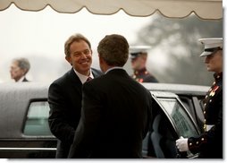 President George W. Bush welcomes British Prime Minister Tony Blair upon his arrival to the White House Friday, Jan. 31, 2003.  White House photo by Paul Morse