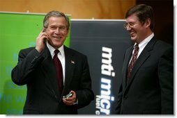 President George W. Bush tries out a cell phone powered by hydrogen fuel cell technology during a demonstration of energy technologies at The National Building Museum in Washington, D.C., Thursday, Feb. 6, 2003. Accompanied by EPA Administrator Christie Todd Whitman and Department of Energy Secretary Spencer Abraham, the President reviewed fuel cell technology in applications ranging from cars to laptop computers.  White House photo by Paul Morse