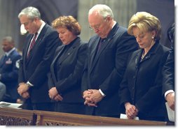 Bowing their heads in prayer, NASA Administrator Sean O'Keefe, far left, Laura O'Keefe, left, Vice President Dick Cheney, center, and Lynne Cheney attend a memorial service for the Space Shuttle Columbia astronauts at the National Cathedral in Washington, D.C., Thursday, Feb. 6, 2003. The seven astronauts died when the space shuttle broke apart upon re-entering the atmosphere Feb. 1, 2003.  White House photo by David Bohrer