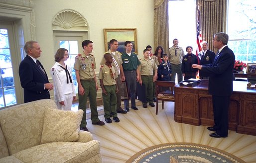 President George W. Bush visits with a delegation from the Boy Scouts of America during the presentation of the annual report by the BSA in the Oval Office Tuesday, Feb. 11, 2003. Participating in the ceremony are, from left, Roy Williams, Emily Petty, Matthew Knight, John Reese, Nick Digirolamo, Sam Stocker, Zachary Gomez, Jonathan Nagata, Bethany Loomis, Jesse Loomis, William Loomis, Carol Pyfer and John Pyfer. White House photo by Eric Draper.