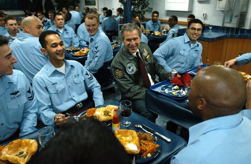 President George W. Bush shares a light moment after lunch with sailors aboard the USS Philippine Sea at Naval Station Mayport in Mayport, Fla., Thursday, Feb. 13, 2003. White House photo by Eric Draper
