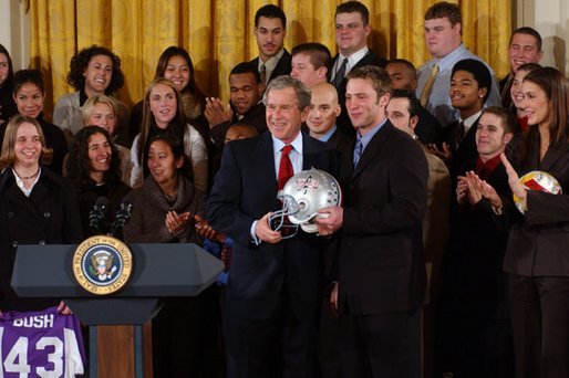 President George W. Bush poses with Andy Groom, captain of Ohio State University's football team, during a visit to the White House by the NCAA Fall Champions Monday, Feb. 24, 2003. White House photo by Tina Hager