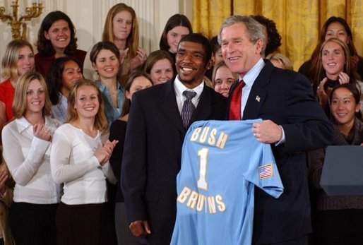 Tony Lawson, captain of the University of California, Los Angeles men's soccer team, presents President George W. Bush with a team jersey during a visit by the NCAA Fall Champions in the East Room Monday, Feb. 24, 2003. White House photo by Tina Hager