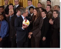 President George W. Bush talks with Lauren Killian, captain of the women's volleyball team at University of Southern California, during a visit by the NCAA Fall Champions to the East Room Monday, Feb. 24, 2003.   White House photo by Tina Hager