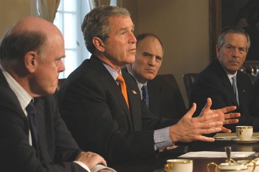As Treasury Secretary John Snow, left, Director of National Economic Council Stephen Friedman, center, and Commerce Secretary Don Evans sit by his side, President George W. Bush takes a few questions from the media during a meeting with the National Economic Council in the Cabinet Room Tuesday, Feb. 25, 2003. White House photo by Eric Draper