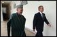 President George W. Bush and President Hamid Karzai of Afghanistan walk through the colonnade after meeting in the Oval Office Thursday, Feb. 27, 2003.  White House photo by Tina Hager