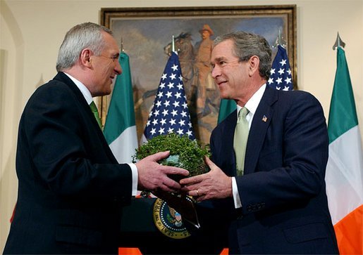 Irish Prime Minister Bertie Ahern presents a shamrock plant to President George W. Bush during an annual shamrock ceremony in the Roosevelt Room Thursday, March 13, 2003. White House photo by Tina Hager