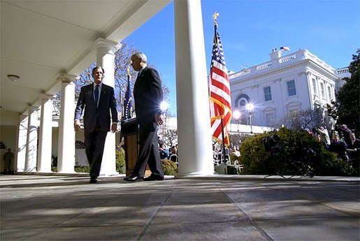 President George W. Bush and Secretary of State Colin Powell walk back to the Oval Office after addressing the media in the Rose Garden Friday, March 14, 2003. The President discussed an outline for peace in the Middle East. White House photo by Paul Morse.