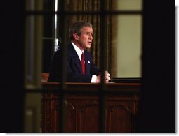 President George W. Bush addresses the nation from the Oval Office at the White House Wednesday evening, March 19, 2003.   White House photo by Paul Morse