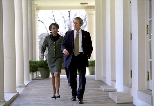 President George W. Bush and National Security Advisor Dr. Condoleezza Rice walk together along the colonnade between the Rose Garden and the Cabinet Room Monday, March 24, 2003. White House photo by Eric Draper.